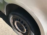 a close up of a car with a flat tire on the side of the road
