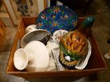 a box full of plates and bowls on the floor