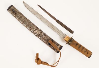 a knife and a knife holder on a white surface