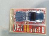 a toy car in a plastic package on a table