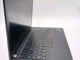 the laptop is open on a white surface with a red button on the keyboard