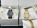 two watches in a white box with a gold chain