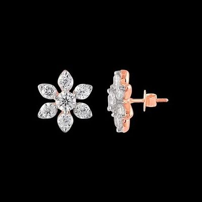 a pair of diamond earrings on a black background