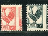 two stamps with a rooster and a rooster on them on a black surface