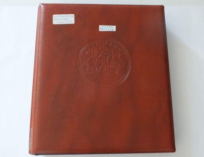 a brown leather album with a circular design on the cover