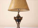 a lamp that is sitting on a table with a lamp shade on it