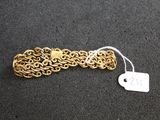 a close up of a gold chain bracelet with a price tag