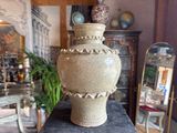 a large vase sitting on top of a table in a room