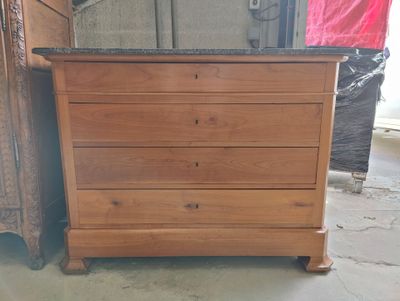 a wooden chest of drawers with a granite top