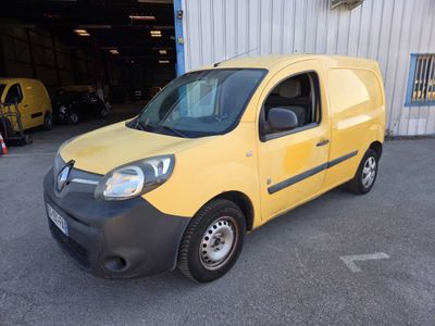 a yellow van parked in front of a building in a parking lot