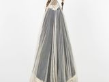 a woman in a wedding dress with a veil on a mannequin