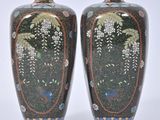 two vases sitting side by side on a white surface
