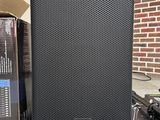 a close up of a speaker sitting on top of a table next to a box