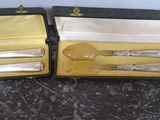 two silverware items in a case on a table