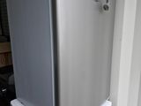 a refrigerator sitting on top of a refrigerator freezer