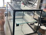 a glass case that is sitting on a table
