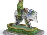 a figurine of a man riding a horse in the water