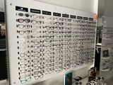 many glasses on display on a white board in a store