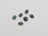 a close up of a group of green and black gems