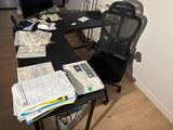 a desk with a chair and a computer on top of it