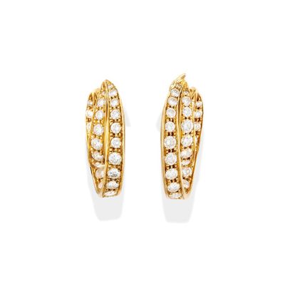 a pair of gold and diamond earrings