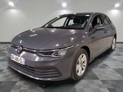 the grey volkswagen golf is parked on a checkered tile floor