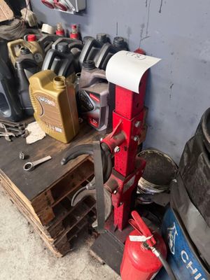 a pile of assorted items on a shelf in a garage