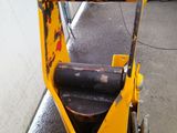 a yellow construction vehicle parked next to a building