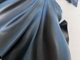 a batman statue on a table next to a piece of paper