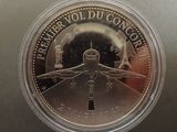 an image of a coin with a picture of a plane on it