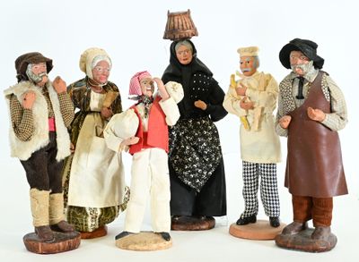 five figurines of people dressed in traditional clothing