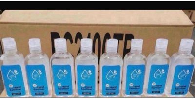 six bottles of hand sanitizer sitting in front of a cardboard box