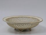 a close up of a white bowl on a white surface