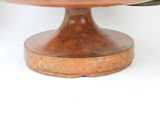 a cake that is on a wooden plate on a table