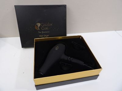 black and gold hair dryer in a black box on a table