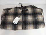 a close up of a blanket on a table with a tag on it