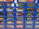 a lot of toy cars that are in a blue box