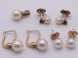 four pairs of pearl earrings and a pair of gold earrings
