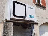 a white microwave sitting on the side of a building