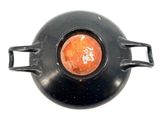 a black pot with a red light in it