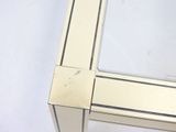 a close up of a glass table with a metal frame