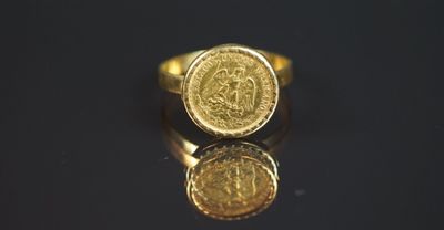 gros plan d'une bague en or sur une surface noire