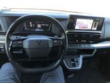 a man sitting in the driver ' s seat of a car