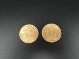a pair of gold earrings with an image of a woman ' s face and a man ' s face