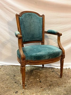 an image of a chair with a blue upholstered seat