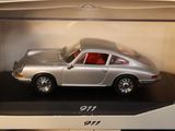 a silver toy car in a box on a table