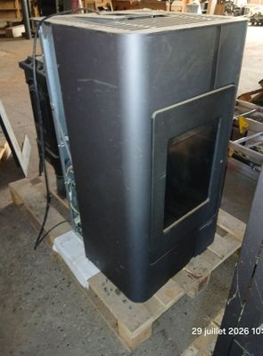 a black oven sitting on top of a pallet in a warehouse