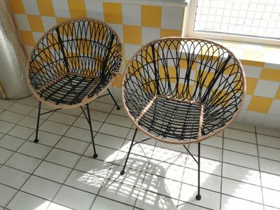 two wicker chairs in a room with yellow and white checkered walls