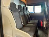 four seats in the back of a bus with a fire extinguisor