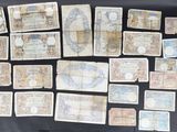 several pieces of old currency are displayed on a black surface